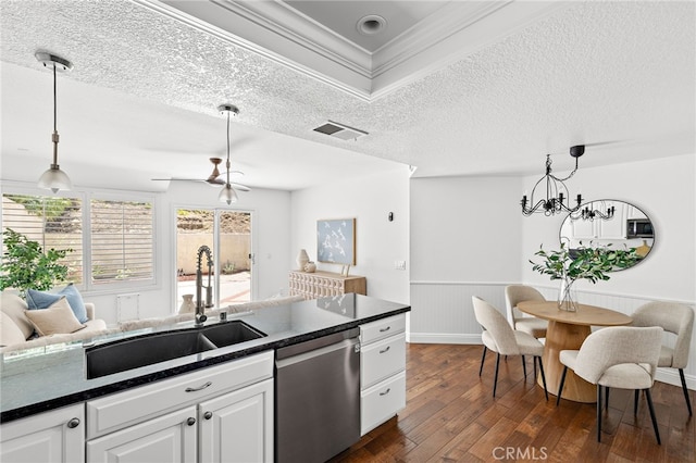 18 Saint Thomas, Laguna Niguel, CA 92677 - kitchen with stainless steel appliances, dark countertops, dark wood-style floors, wainscoting, and white cabinets