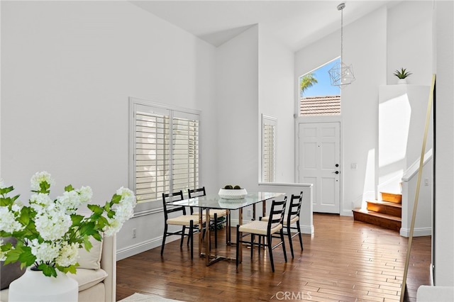 18 Saint Thomas, Laguna Niguel, CA 92677 - dining room featuring a towering ceiling, hardwood / wood-style floors, stairway, and a chandelier