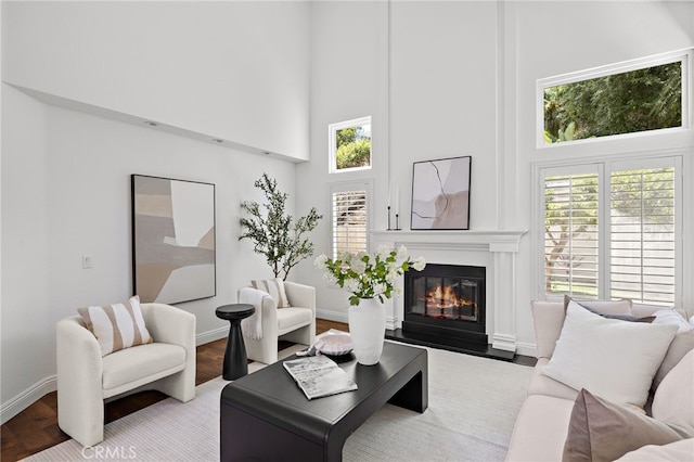 18 Saint Thomas, Laguna Niguel, CA 92677 - living area featuring a high ceiling, a glass covered fireplace, and wood finished floors