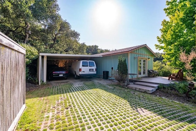 2310 Oak Haven Ln, Arroyo Grande, CA 93420 - rear view of house with french doors, a carport, a yard, board and batten siding, and driveway