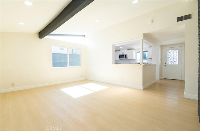 13870 Larwin Rd, La Mirada, CA 90638 - unfurnished living room featuring light wood finished floors, recessed lighting, and beamed ceiling