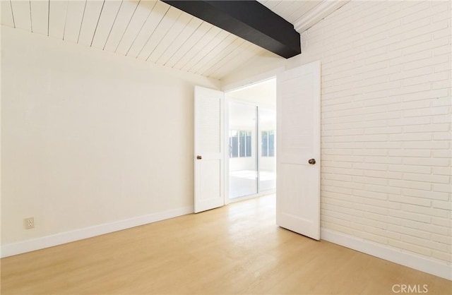 13870 Larwin Rd, La Mirada, CA 90638 - spare room with light wood-type flooring, wood ceiling, and brick wall