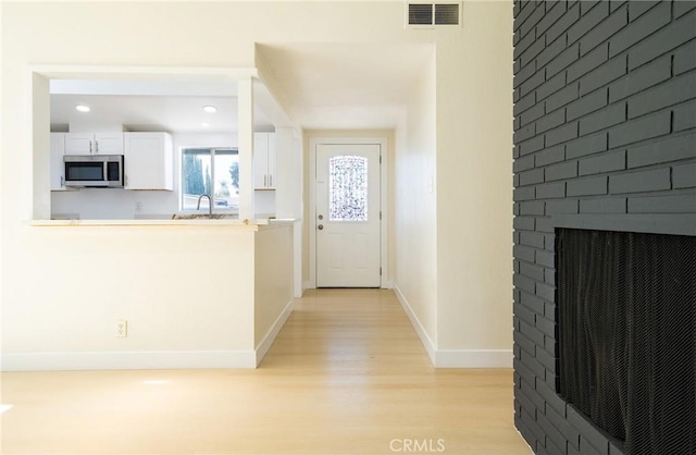 13870 Larwin Rd, La Mirada, CA 90638 - foyer with light wood-style floors, recessed lighting, and a fireplace