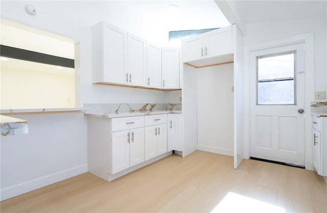 13870 Larwin Rd, La Mirada, CA 90638 - kitchen featuring light wood-style floors, light countertops, and white cabinets
