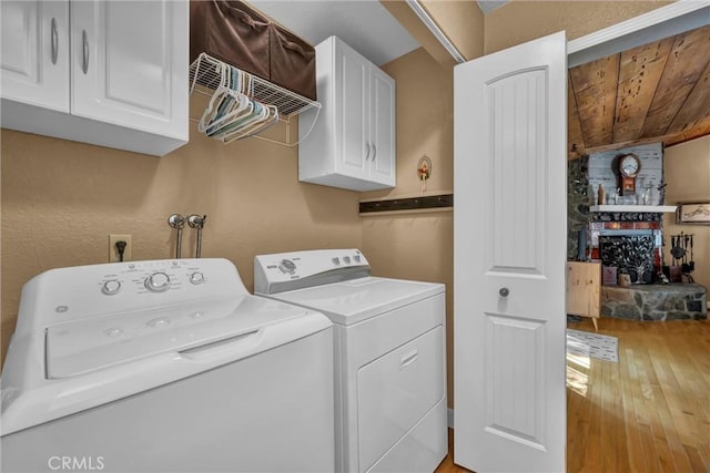 16635 Mountain View Dr, Cobb, CA 95426 - laundry area with cabinet space, washer and clothes dryer, hardwood / wood-style floors, and wooden ceiling