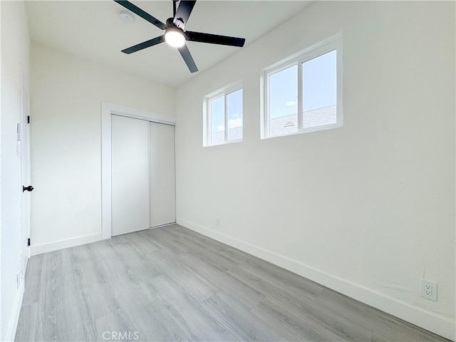 10408 Kalmia St, Los Angeles, CA 90002 - unfurnished bedroom featuring light wood-style floors, a closet, and a ceiling fan