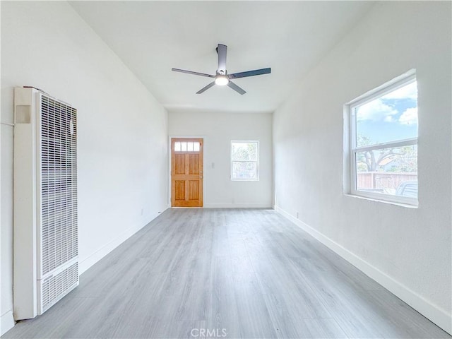 10408 Kalmia St, Los Angeles, CA 90002 - unfurnished living room with a heating unit, light wood-type flooring, and ceiling fan