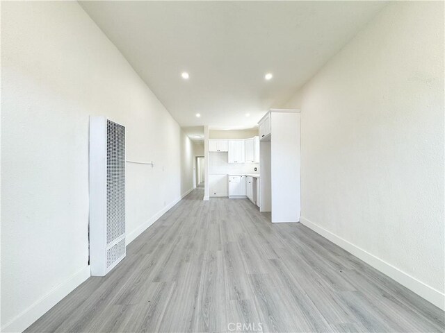 10408 Kalmia St, Los Angeles, CA 90002 - unfurnished living room featuring a heating unit, light wood-type flooring, and recessed lighting