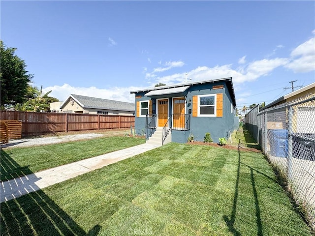 10408 Kalmia St, Los Angeles, CA 90002 - view of front facade featuring stucco siding, a fenced backyard, and solar panels