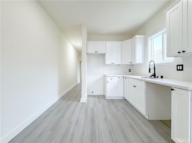 10408 Kalmia St, Los Angeles, CA 90002 - kitchen with light wood-style flooring, white cabinets, and light countertops