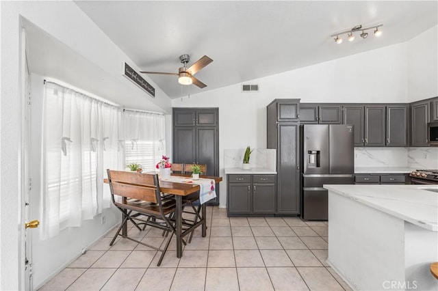 2019 Greentree St, Lancaster, CA 93535 - kitchen featuring appliances with stainless steel finishes, vaulted ceiling, ceiling fan, light tile patterned flooring, and gray cabinetry