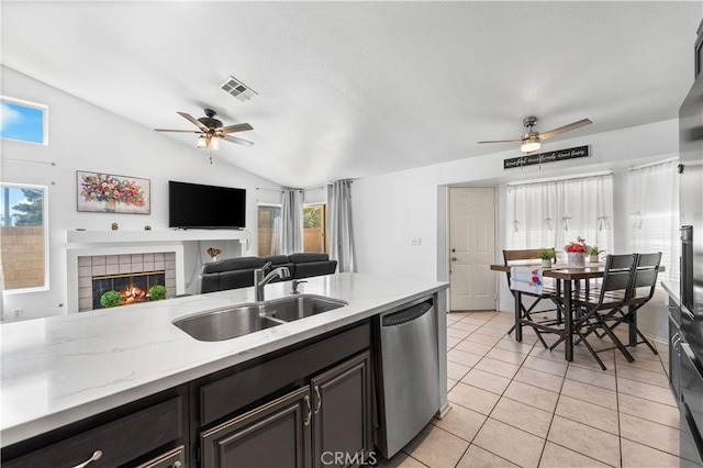 2019 Greentree St, Lancaster, CA 93535 - kitchen featuring ceiling fan, dishwasher, lofted ceiling, a tiled fireplace, and light tile patterned flooring