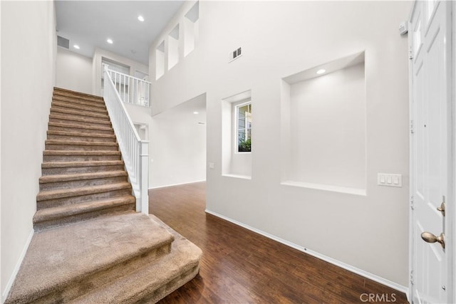 39886 Worthington Pl, Temecula, CA 92591 - stairs featuring wood finished floors, a high ceiling, and recessed lighting