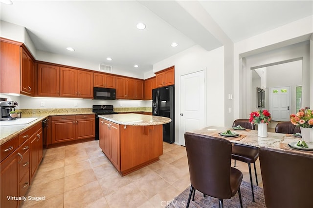 39886 Worthington Pl, Temecula, CA 92591 - kitchen featuring black appliances, a center island, light stone counters, recessed lighting, and brown cabinets