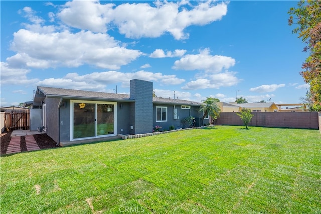 5839 Los Santos Way, Buena Park, CA 90620 - back of property featuring a fenced backyard, stucco siding, and a chimney