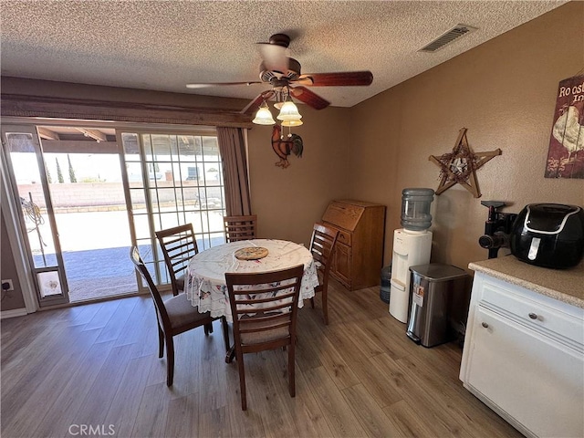 811 Mescal Dr, Barstow, CA 92311 - dining area featuring wood finished floors, a textured ceiling, and ceiling fan
