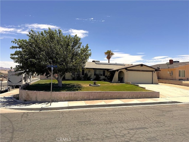 811 Mescal Dr, Barstow, CA 92311 - ranch-style house featuring a front lawn, driveway, a garage, and solar panels