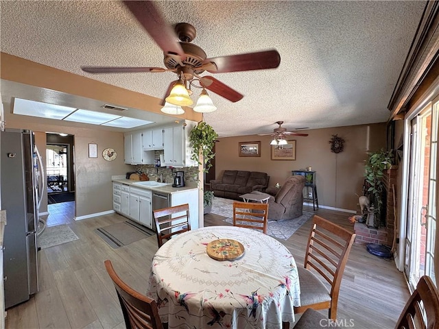 811 Mescal Dr, Barstow, CA 92311 - dining space with ceiling fan, a textured ceiling, healthy amount of natural light, and light wood-style floors