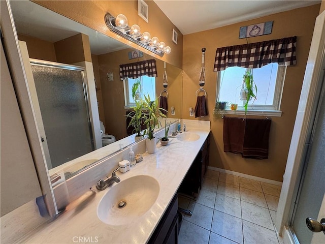 811 Mescal Dr, Barstow, CA 92311 - bathroom featuring double vanity, a stall shower, and tile patterned flooring