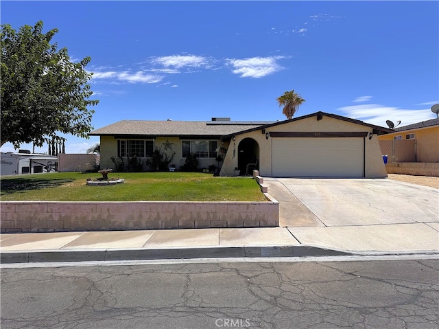 811 Mescal Dr, Barstow, CA 92311 - ranch-style house featuring stucco siding, an attached garage, solar panels, and a front lawn