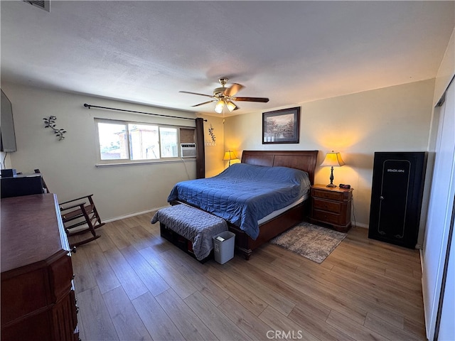 811 Mescal Dr, Barstow, CA 92311 - bedroom featuring wood finished floors, cooling unit, and ceiling fan