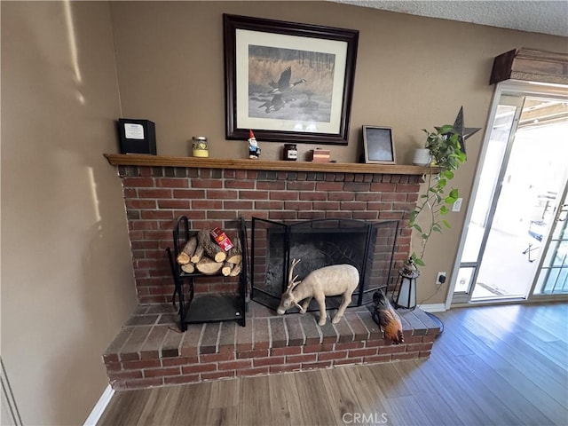 811 Mescal Dr, Barstow, CA 92311 - detailed view of wood finished floors and a brick fireplace