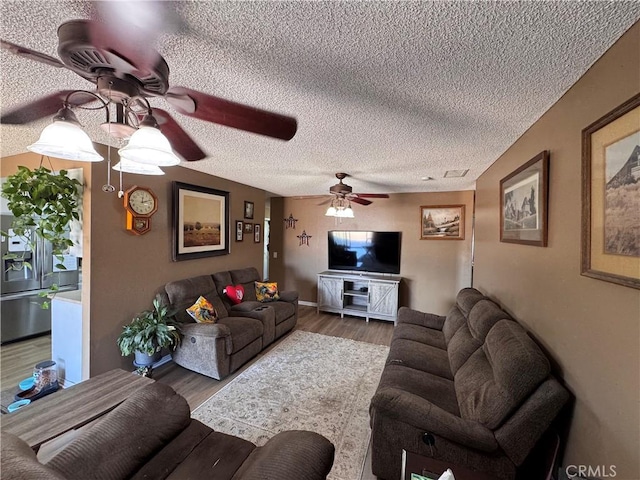 811 Mescal Dr, Barstow, CA 92311 - living room with ceiling fan, wood finished floors, and a textured ceiling