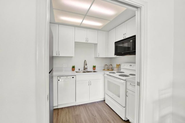 1508 Circa Del Lago Unit B205, San Marcos, CA 92078 - kitchen featuring white appliances, white cabinets, light countertops, and light wood-style flooring