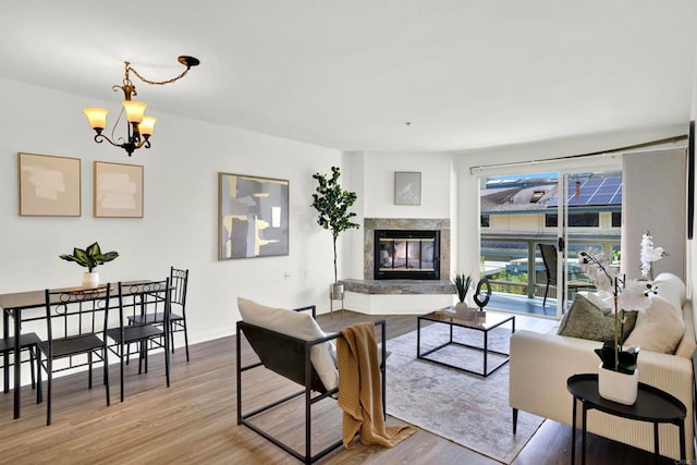 1508 Circa Del Lago Unit B205, San Marcos, CA 92078 - living area featuring wood finished floors, a chandelier, and a premium fireplace
