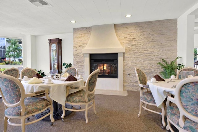 1508 Circa Del Lago Unit B205, San Marcos, CA 92078 - dining area featuring a large fireplace, carpet, wooden ceiling, and recessed lighting