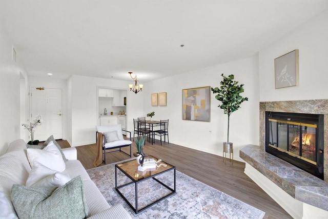 1508 Circa Del Lago Unit B205, San Marcos, CA 92078 - living room featuring a chandelier, dark wood finished floors, and a high end fireplace