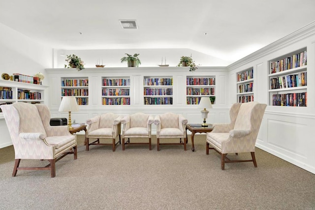 1508 Circa Del Lago Unit B205, San Marcos, CA 92078 - sitting room featuring carpet flooring, bookshelves, vaulted ceiling, and built in shelves