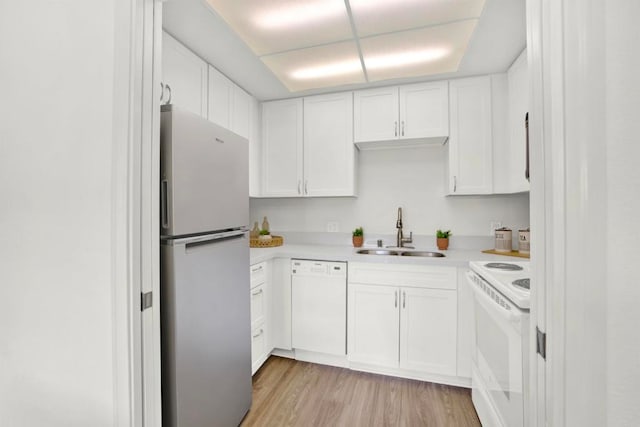 1508 Circa Del Lago Unit B205, San Marcos, CA 92078 - kitchen featuring white appliances, light countertops, white cabinetry, and light wood-style floors