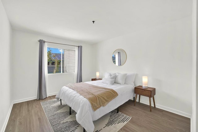 1508 Circa Del Lago Unit B205, San Marcos, CA 92078 - bedroom featuring wood finished floors and baseboards