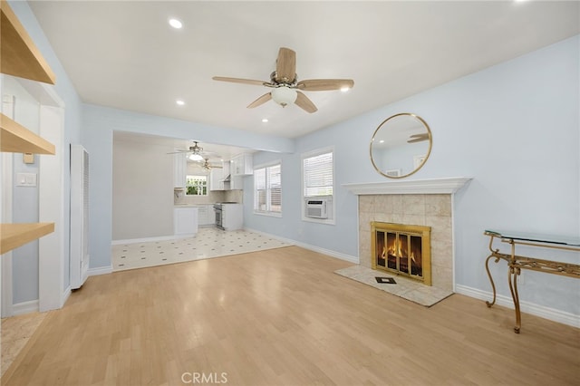 8328 Fernadel Ave, Pico Rivera, CA 90660 - unfurnished living room with ceiling fan, a tiled fireplace, light wood-style floors, a heating unit, and recessed lighting