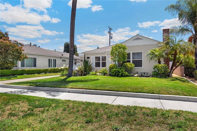 8328 Fernadel Ave, Pico Rivera, CA 90660 - view of front of house with a front yard, stucco siding, and a chimney