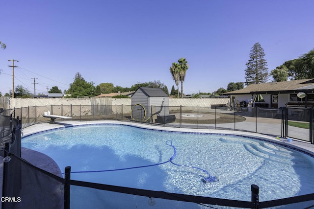 6100 Carter Ave, Bakersfield, CA 93308 - view of pool featuring a patio area, a fenced backyard, a storage unit, and a diving board