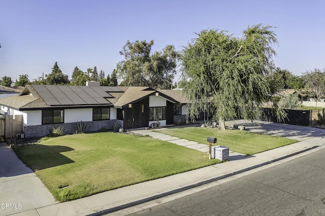 6100 Carter Ave, Bakersfield, CA 93308 - view of front facade with roof mounted solar panels and stucco siding