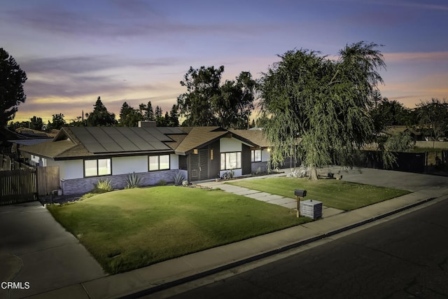 6100 Carter Ave, Bakersfield, CA 93308 - ranch-style home featuring roof mounted solar panels, stucco siding, and stone siding