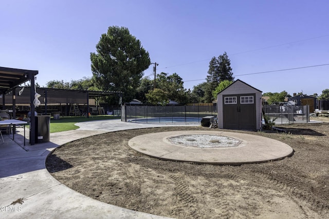 6100 Carter Ave, Bakersfield, CA 93308 - view of yard featuring a storage unit and a patio area