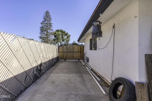 6100 Carter Ave, Bakersfield, CA 93308 - view of side of home featuring a gate and stucco siding