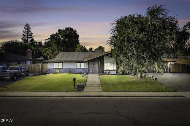 6100 Carter Ave, Bakersfield, CA 93308 - view of front of property with solar panels and stucco siding