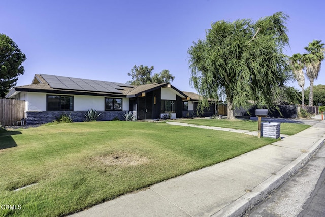 6100 Carter Ave, Bakersfield, CA 93308 - ranch-style house with stucco siding, solar panels, and stone siding