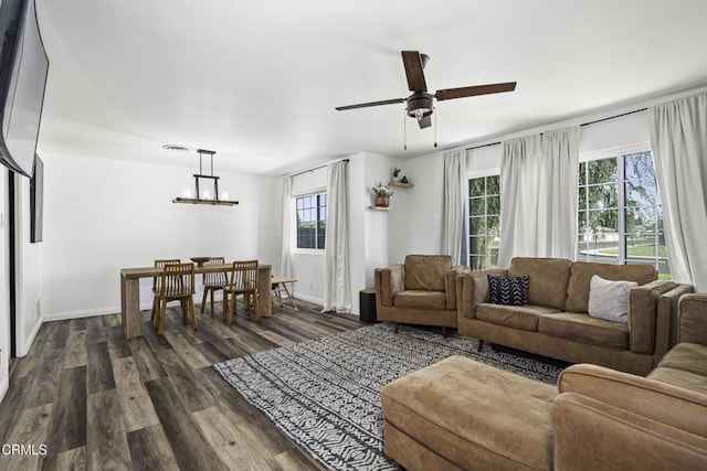 6100 Carter Ave, Bakersfield, CA 93308 - living room with dark wood-type flooring, a ceiling fan, and a chandelier
