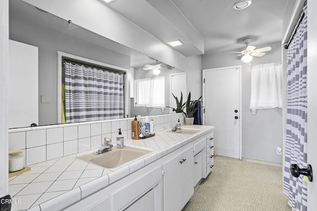 6100 Carter Ave, Bakersfield, CA 93308 - bathroom with ceiling fan, backsplash, and double vanity