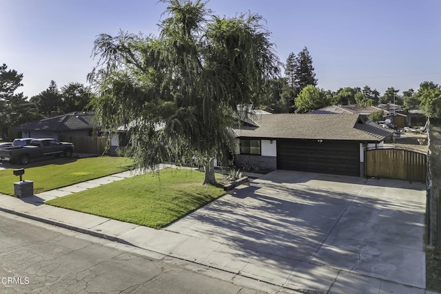6100 Carter Ave, Bakersfield, CA 93308 - view of front facade with driveway, a front yard, an attached garage, roof with shingles, and a gate