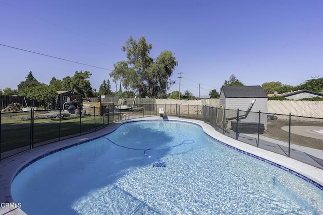 6100 Carter Ave, Bakersfield, CA 93308 - view of swimming pool with a storage shed and a fenced backyard