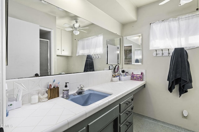 6100 Carter Ave, Bakersfield, CA 93308 - bathroom featuring ceiling fan, vanity, a shower stall, and backsplash