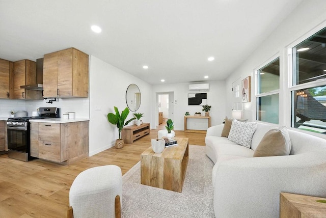 640 Pyramid St, San Diego, CA 92114 - living room featuring light wood-style flooring, a wall mounted AC, and recessed lighting