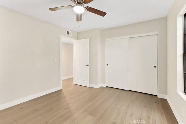 2639 Cameron Unit 119, Anaheim, CA 92801 - unfurnished bedroom with light wood-type flooring, a closet, and a ceiling fan